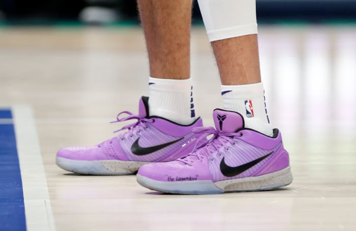 Devin Booker wears a pair of Nike Kobe 4 Protro in a violet colored PE.